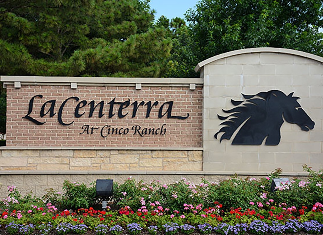 Katy, TX - Closeup View of LaCenterra Sign with a Horse at Cinco Ranch in Katy Texas in Front of Colorful Blooming Flowers